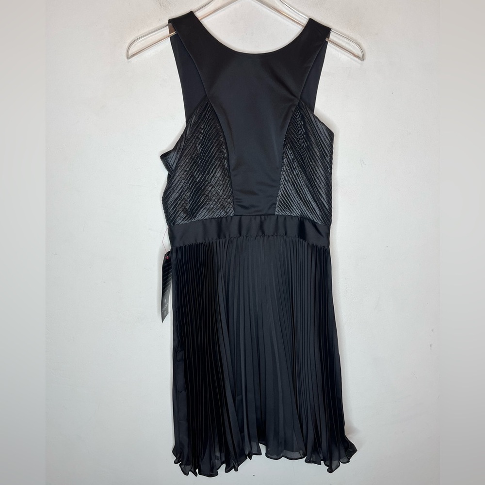 BEBE  Black Mix Fabric Pleat Skirt Cocktail Dress. New With Tags. Size 4